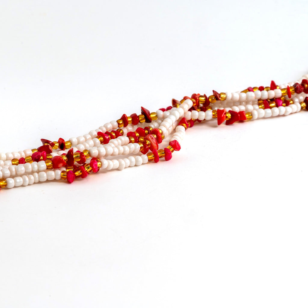 Creamy white, gold waist beads with red crystals and a clasp.