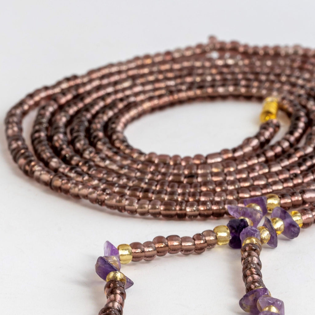 Transparent  plum and gold waist bead with purple crystals and claps. 