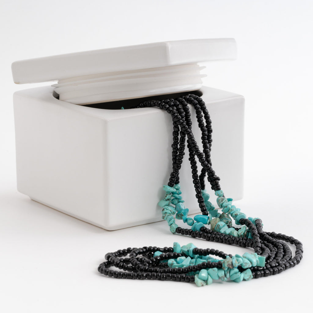 Black beads and turquoise waist beads with clasp.